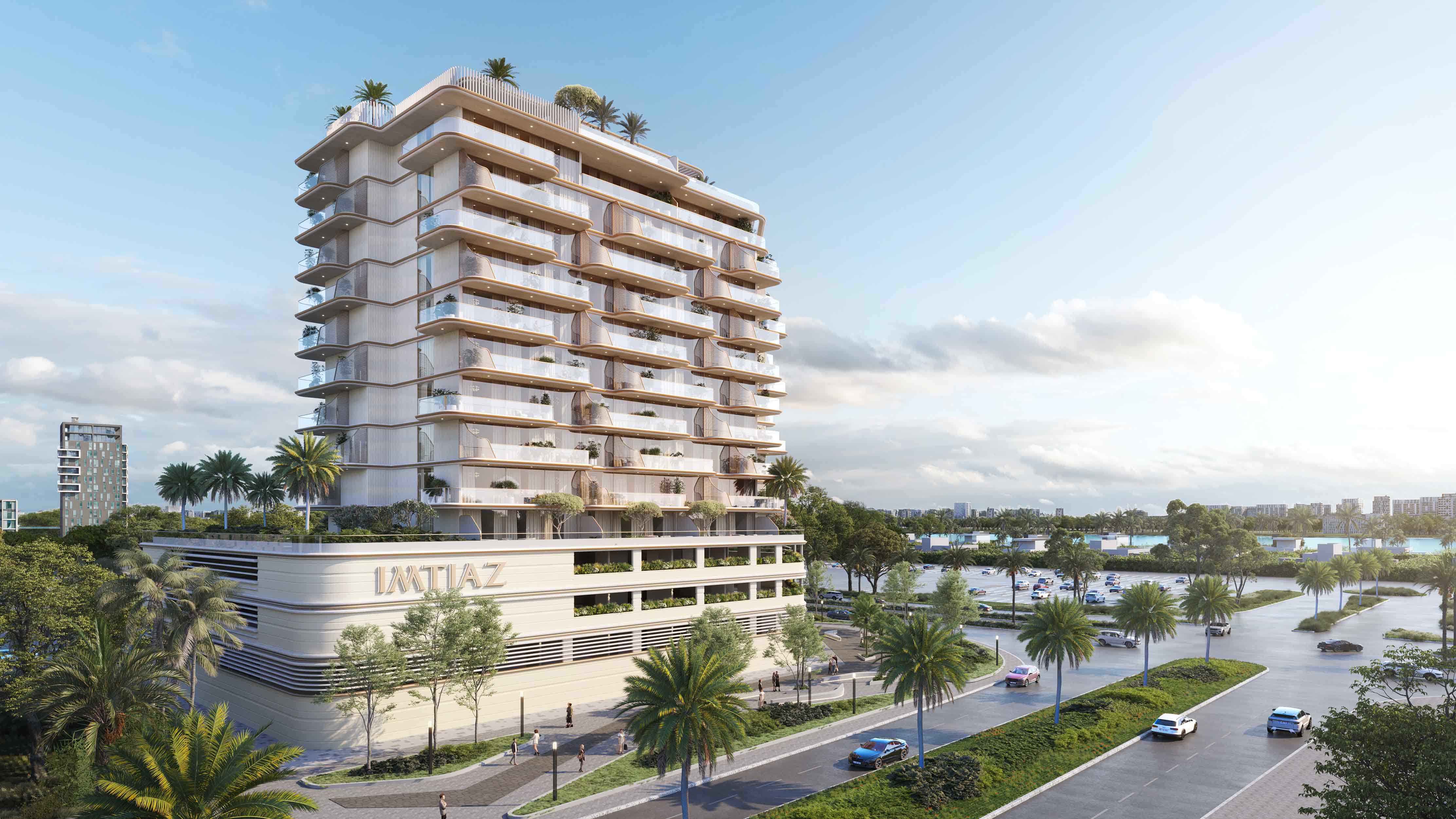 Sunset Bay Grand By Imtiaz A modern, multi-story building surrounded by palm trees and greenery, with cars on the road and a water view.